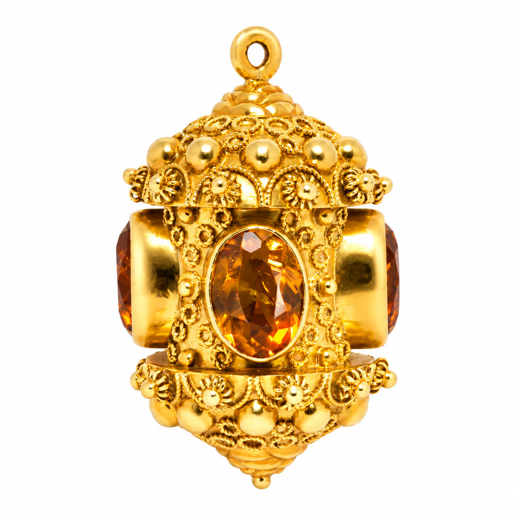 A VINTAGE ETRUSCAN STYLE CITRINE AND 18K GOLD CHARM